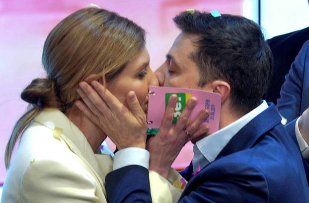 Candidate Zelenskiy kisses his wife Olena following the announcement of an exit poll in Ukraine