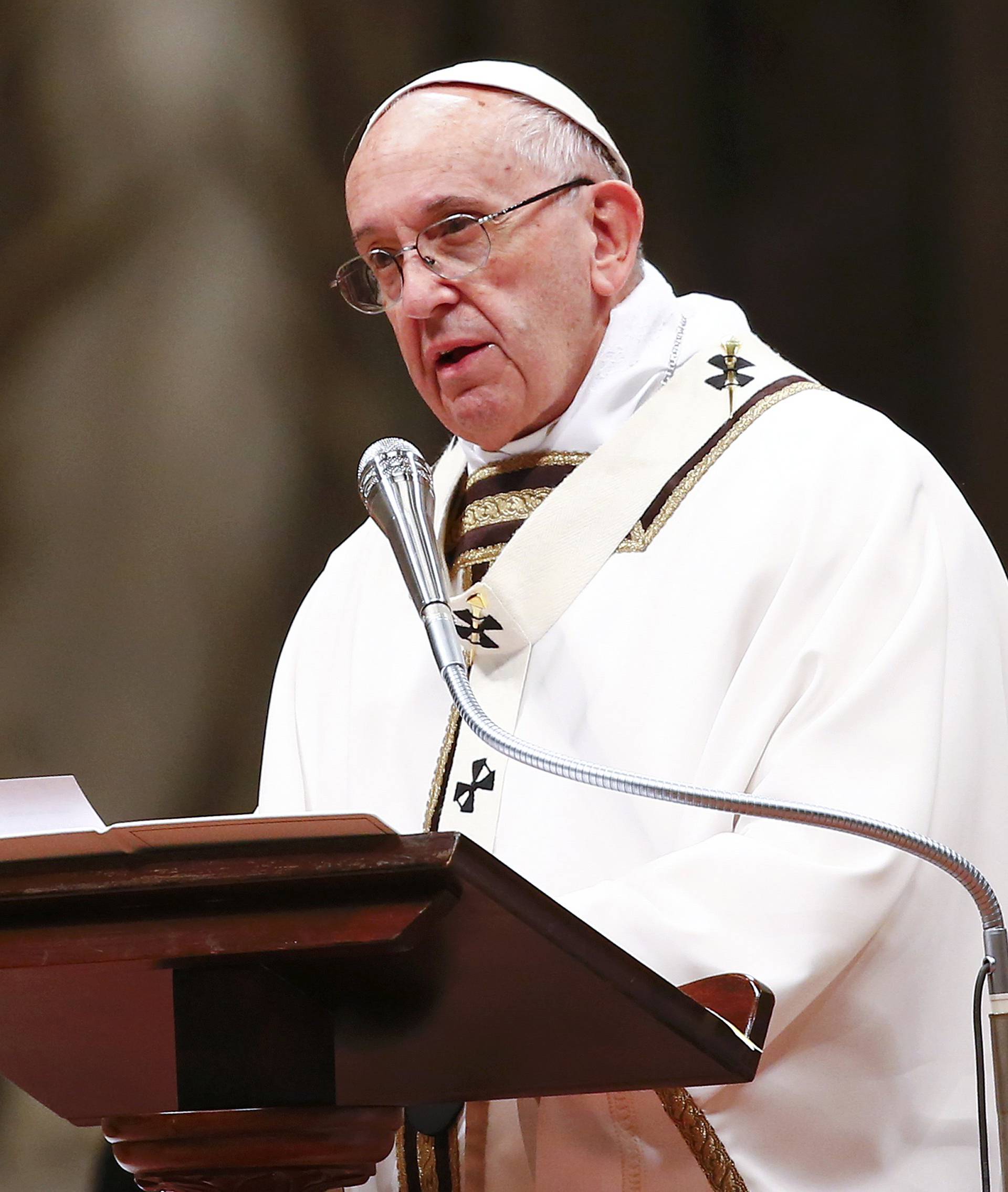 Pope Francis speaks as he leads the Christmas night Mass in Saint Peter's Basilica at the Vatican