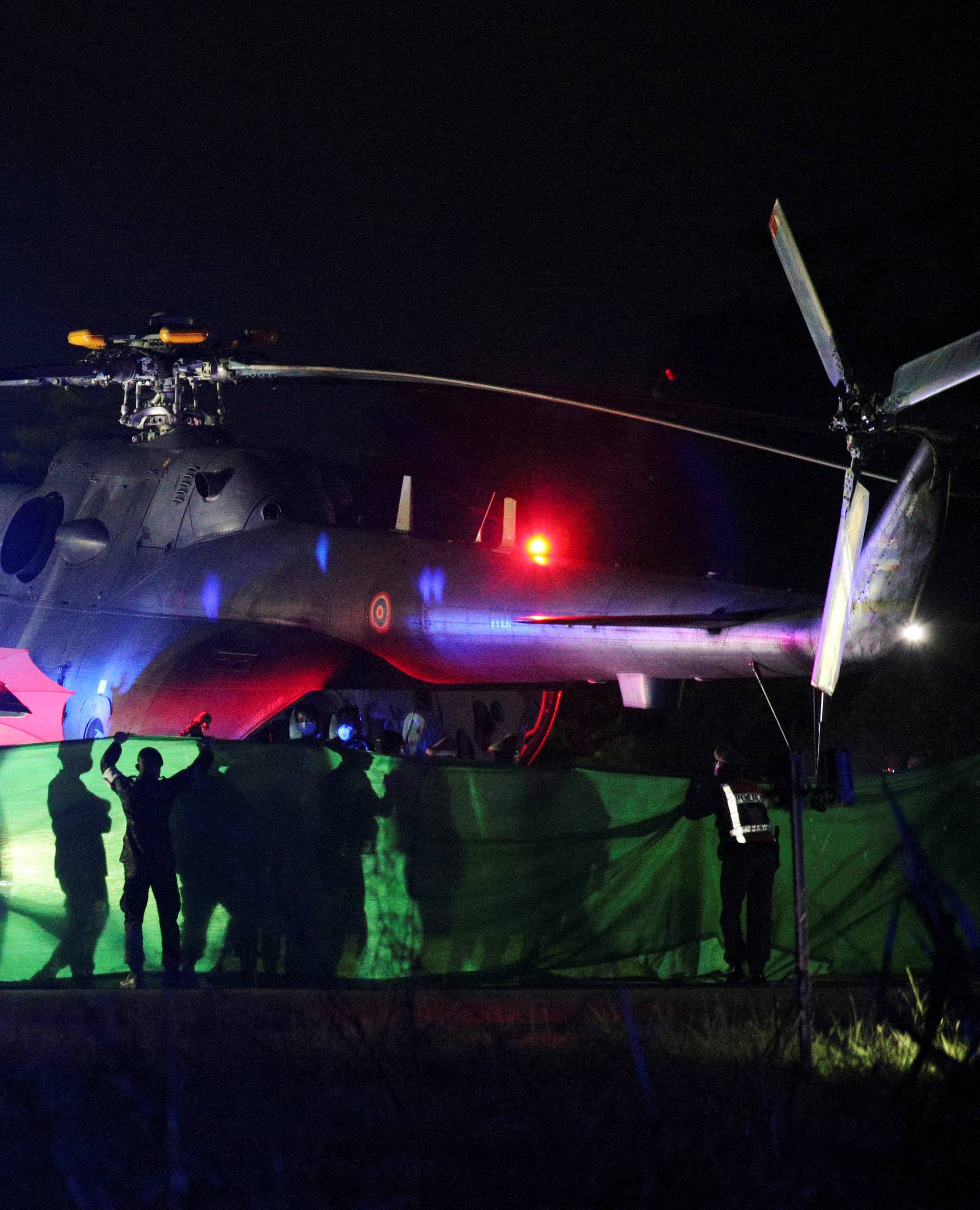 Rescued schoolboys are moved from a military helicopter to an awaiting ambulance at a military airport in Chiang Rai
