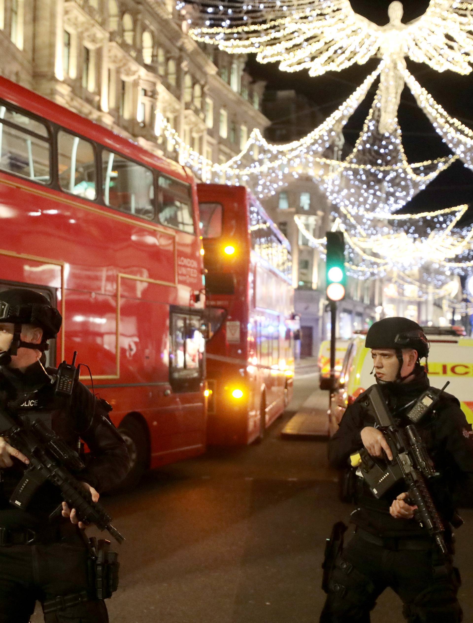 Armed police officers stand on Oxford Street, London