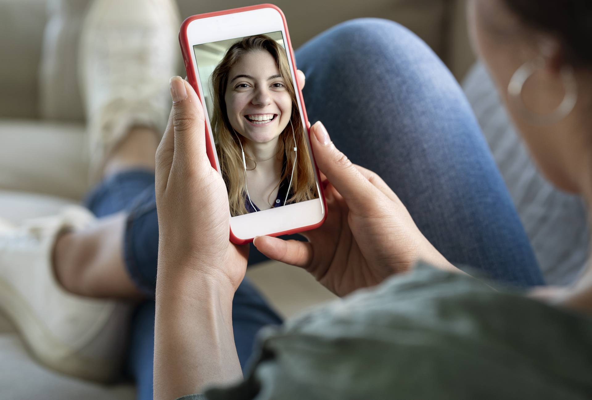 Young woman using smartphone for video call