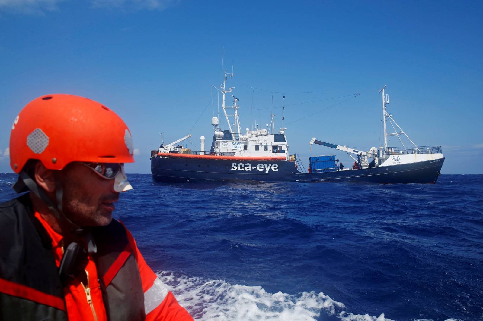 FILE PHOTO: Crew member of the German NGO Sea-Eye migrant rescue ship 'Alan Kurdi' takes part in a training exercise while on their way to the search and rescue zone off the North African coast, in the western Mediterranean Sea