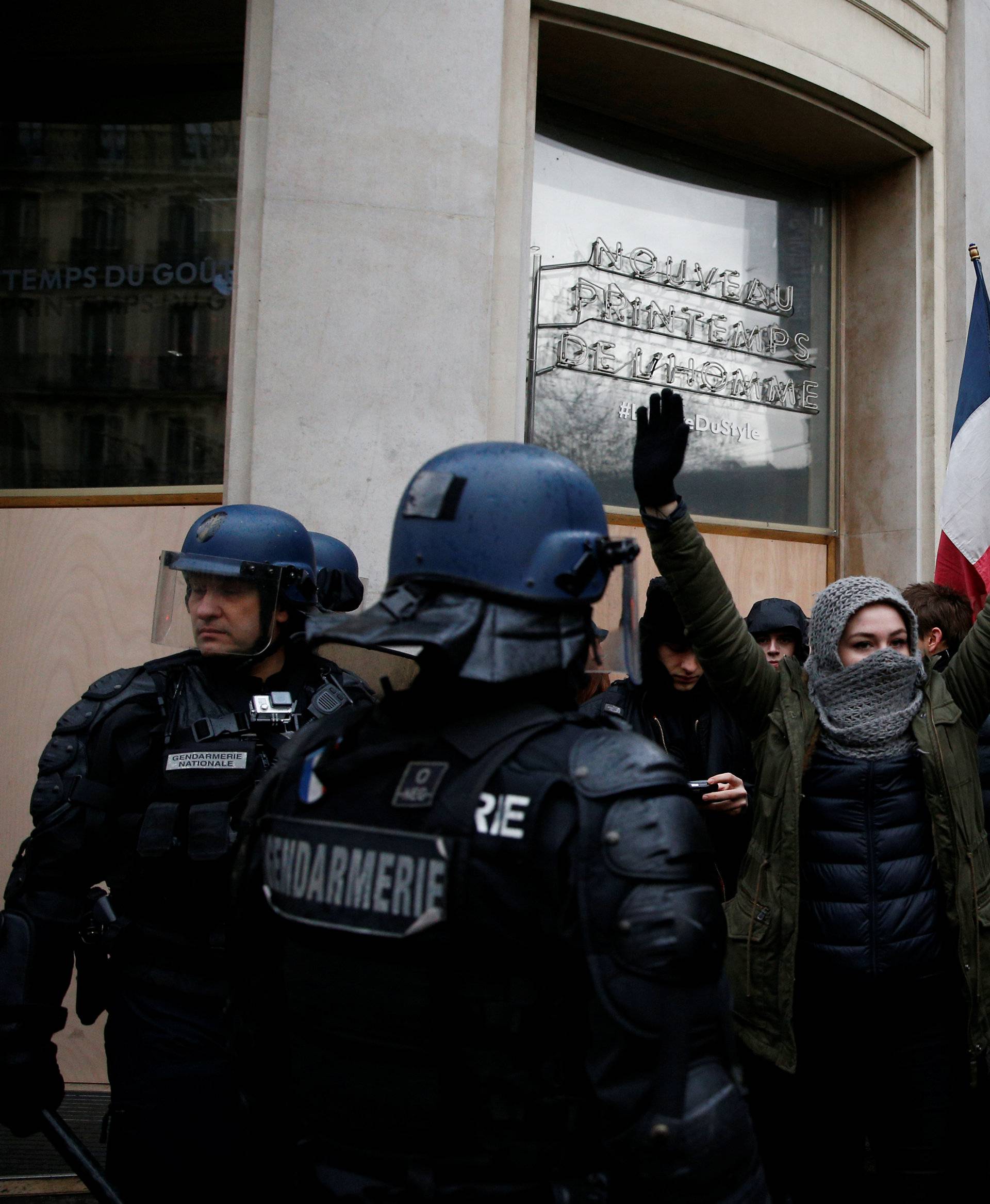 People face off with French Gendarmes as they demonstrate during a national day of protest by the "yellow vests" movement in Paris