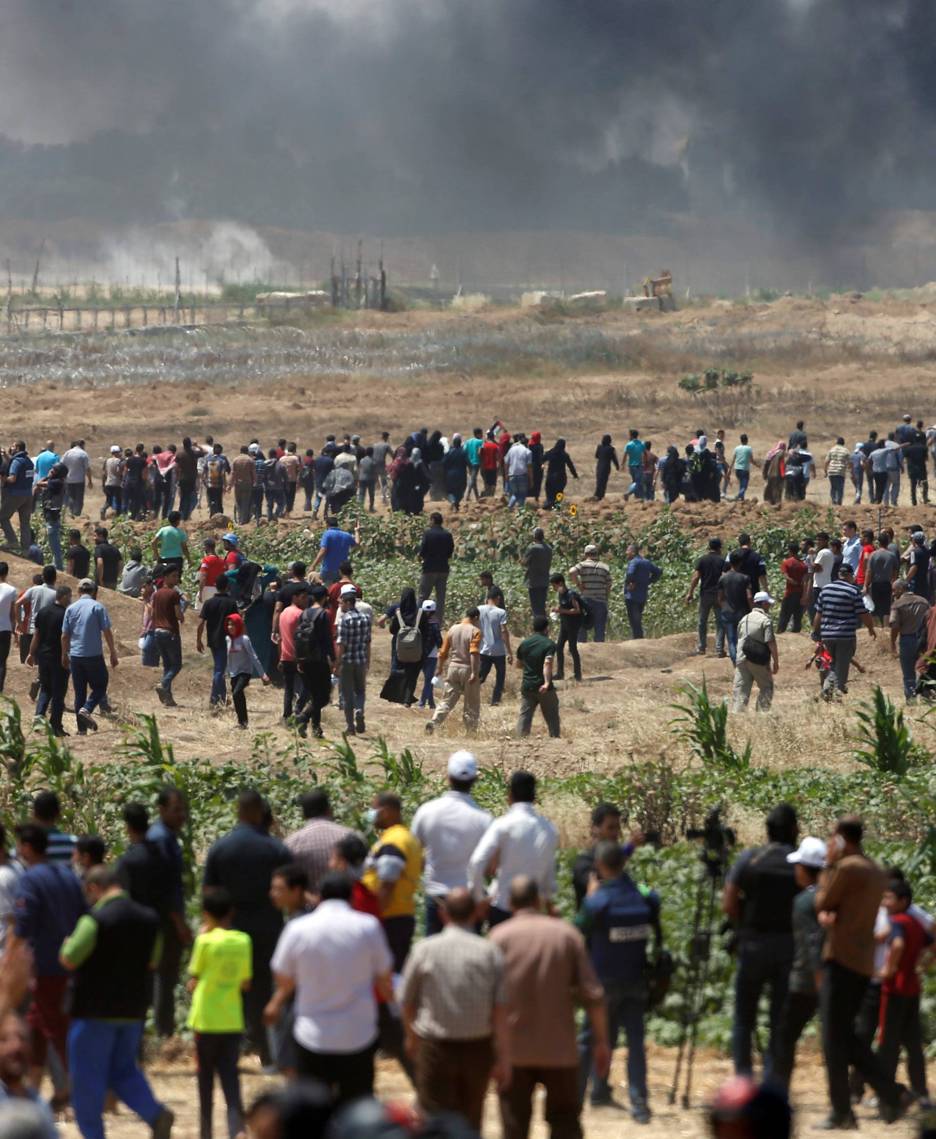 Palestinian demonstrators gather at the Israel-Gaza border during a protest against U.S. embassy move to Jerusalem and ahead of the 70th anniversary of Nakba, east of Gaza City