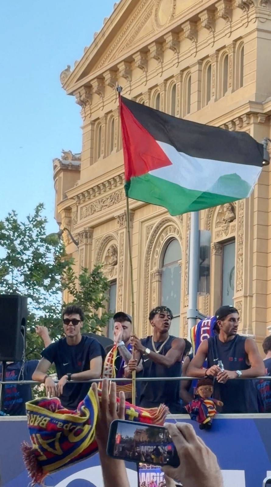 Lamine Yamal waves a Palestinian flag during FC Barcelona's open-top victory parade to celebrate winning LaLiga, in Barcelona