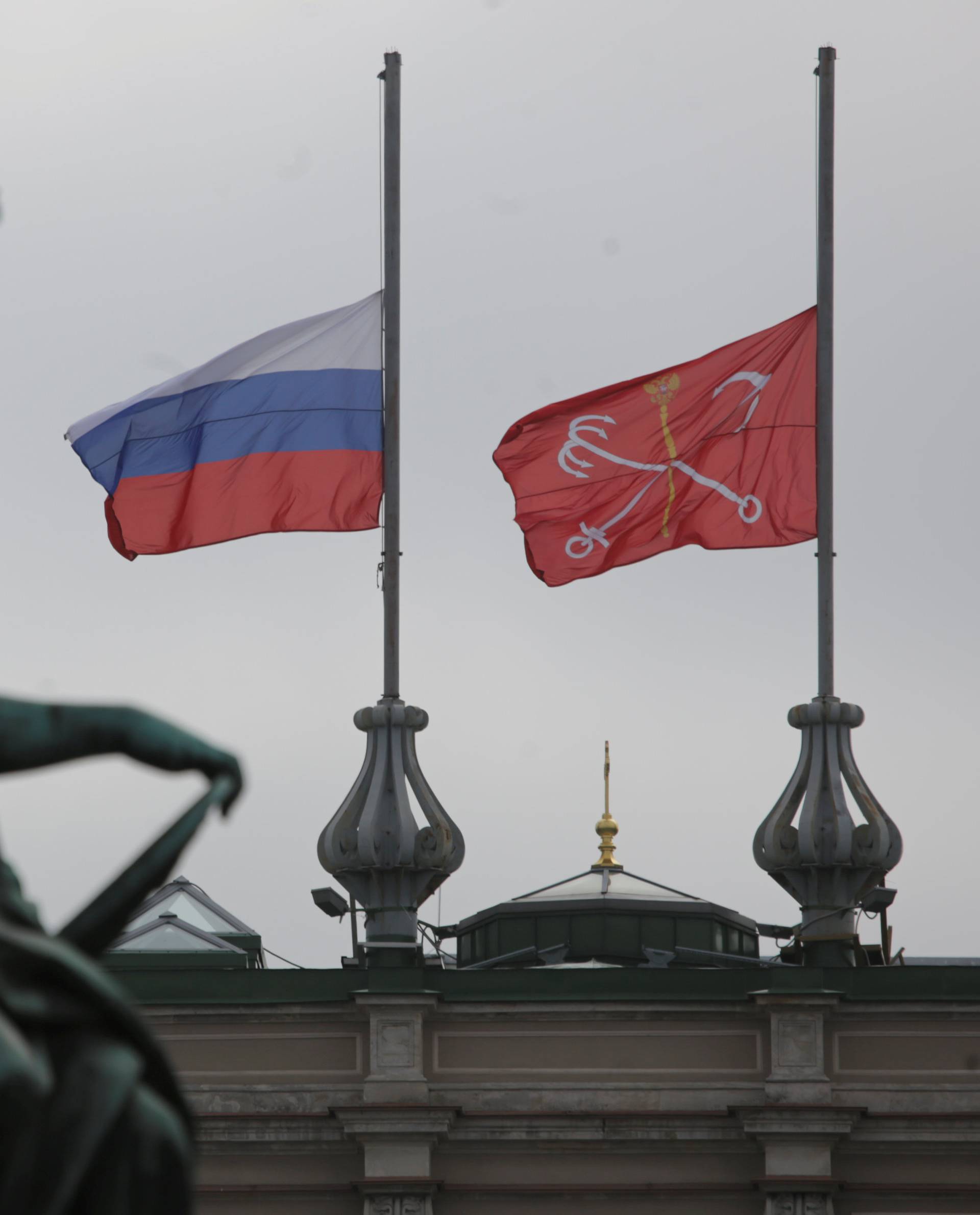 The Russian national flag and the flag of St. Petersburg fly at half-mast in tribute to the victims of a blast in St.Petersburg metro on April 3, at the Mariinsky theatre in St. Petersburg