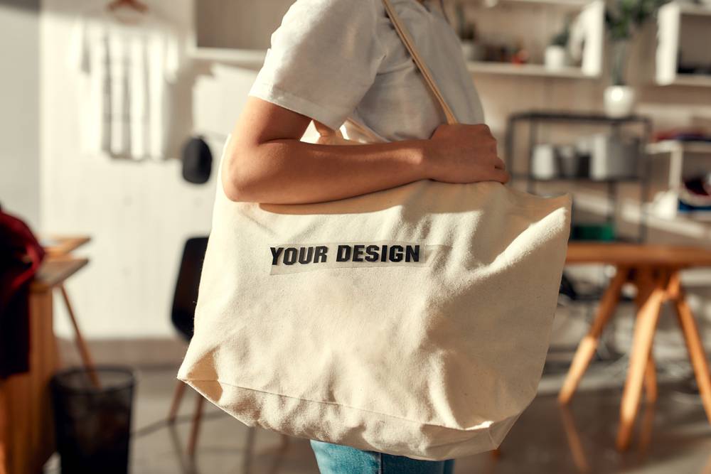 Cropped,Shot,Of,Female,Worker,Posing,With,Custom,Shopper,Bag