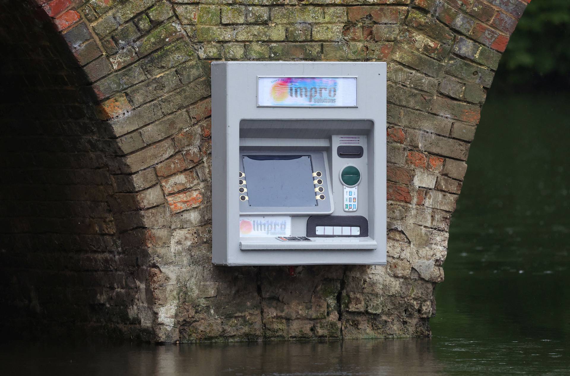 Art installation of an ATM cashpoint, attributed to anonymous artist Impro, on Sonning Bridge in Sonning