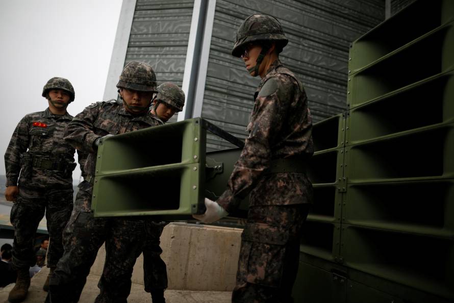 South Korean soldiers dismantle loudspeakers that were set up for propaganda broadcasts near the demilitarized zone separating the two Koreas in Paju