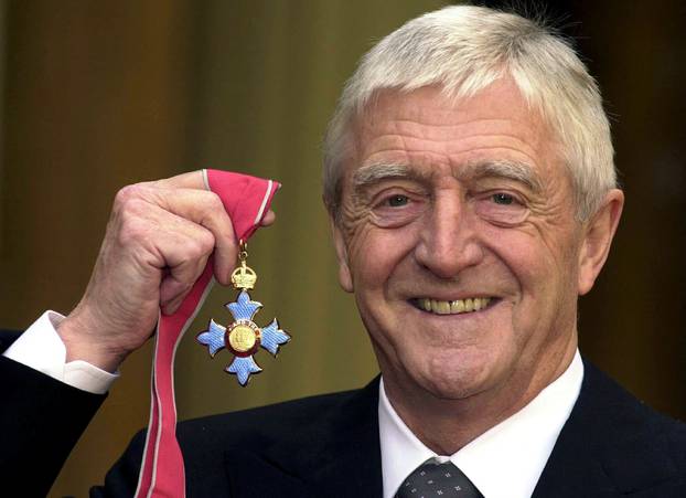 FILE PHOTO: MICHAEL PARKINSON POSE WITH HIS MBE AFTER INVESTITURE.