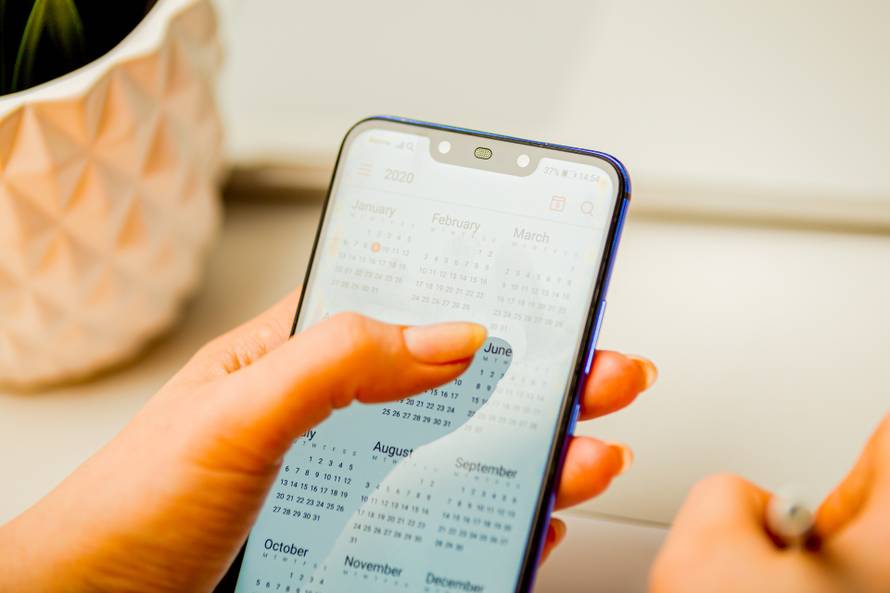 Phone calendar. Planning your day concept. Woman using mobile.