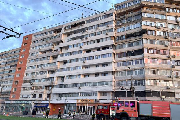 Firefighters and law enforcement work on the site of an explosion at a residential block of flats following a drone hit close to the border with Ukraine