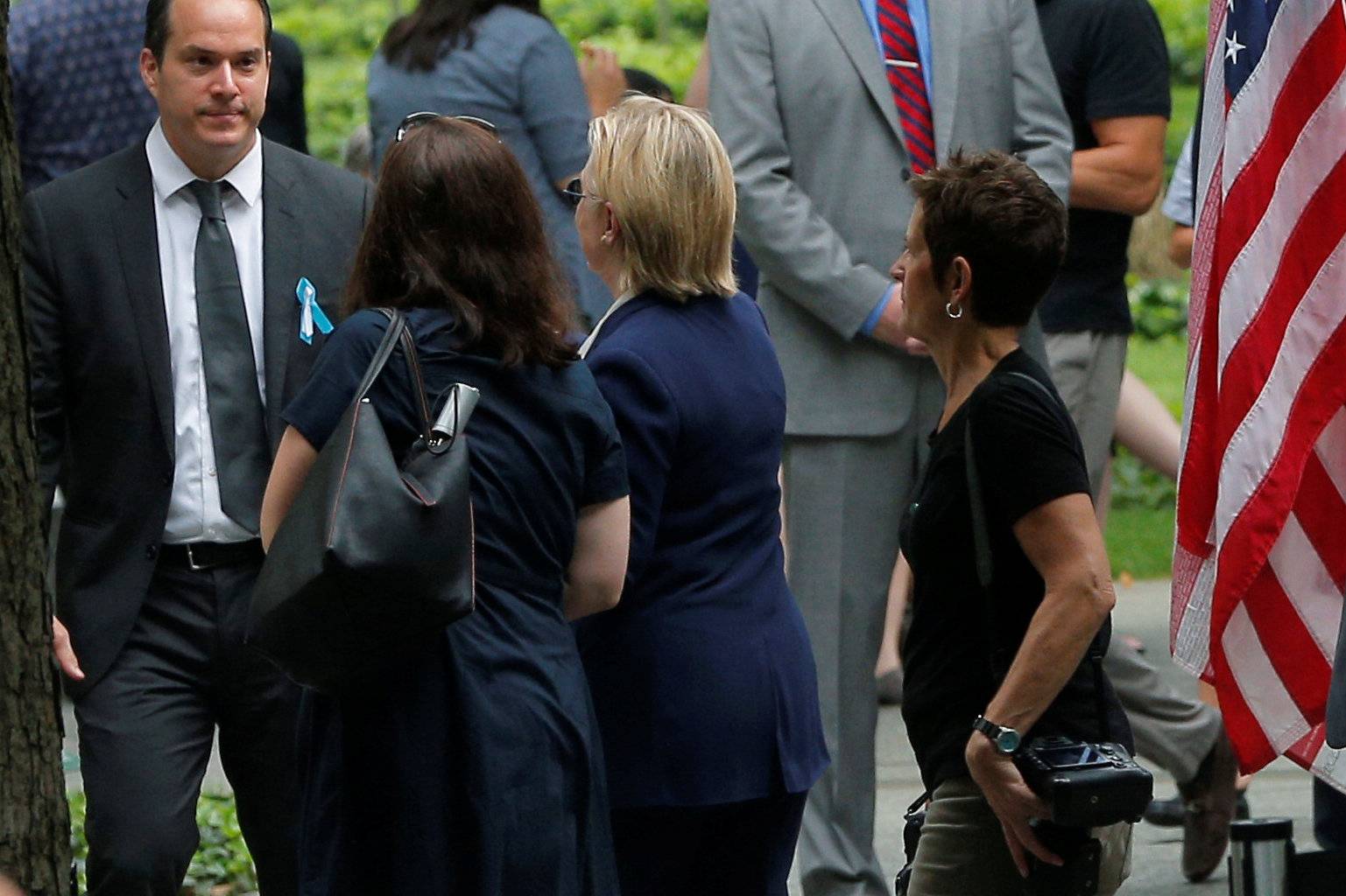 U.S. Democratic presidential candidate Hillary Clinton leaves ceremonies marking the 15th anniversary of the September 11 attacks at the National 9/11 Memorial in New York