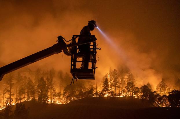 Glass Fire burns as an employee of CableCom installs fiber optic cable in Calistoga, California