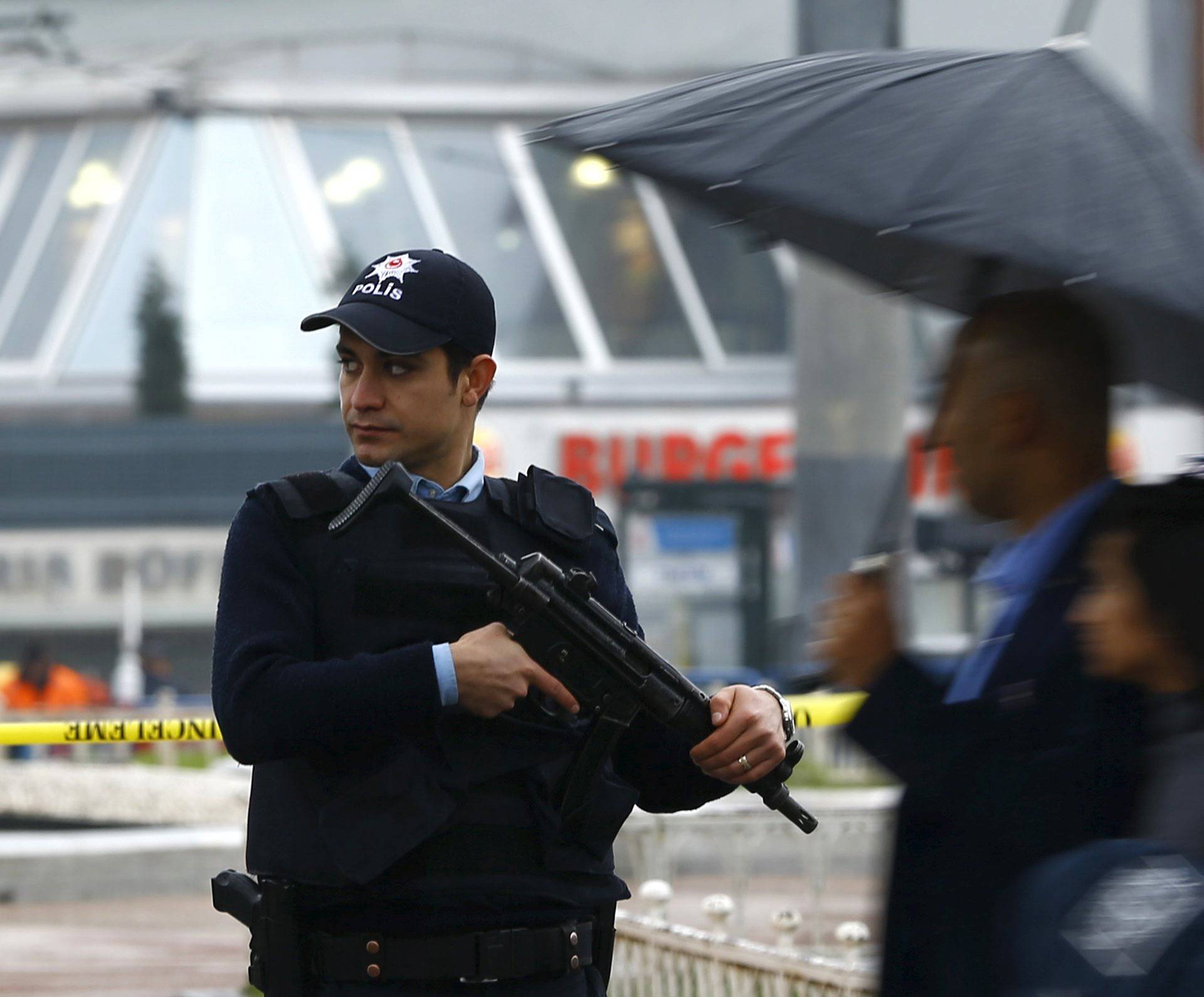 A police officer stands at Taksim square after a suicide bombing on a major shopping and tourist district in central Istanbul