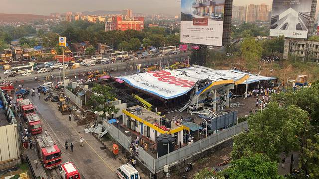 An aerial view shows a fallen billboard on a fuel station following a wind and dust storm in Mumbai