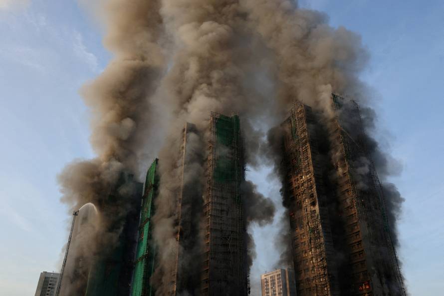 Flames engulf bamboo scaffolding across multiple buildings at Wang Fuk Court housing estate, in Tai Po