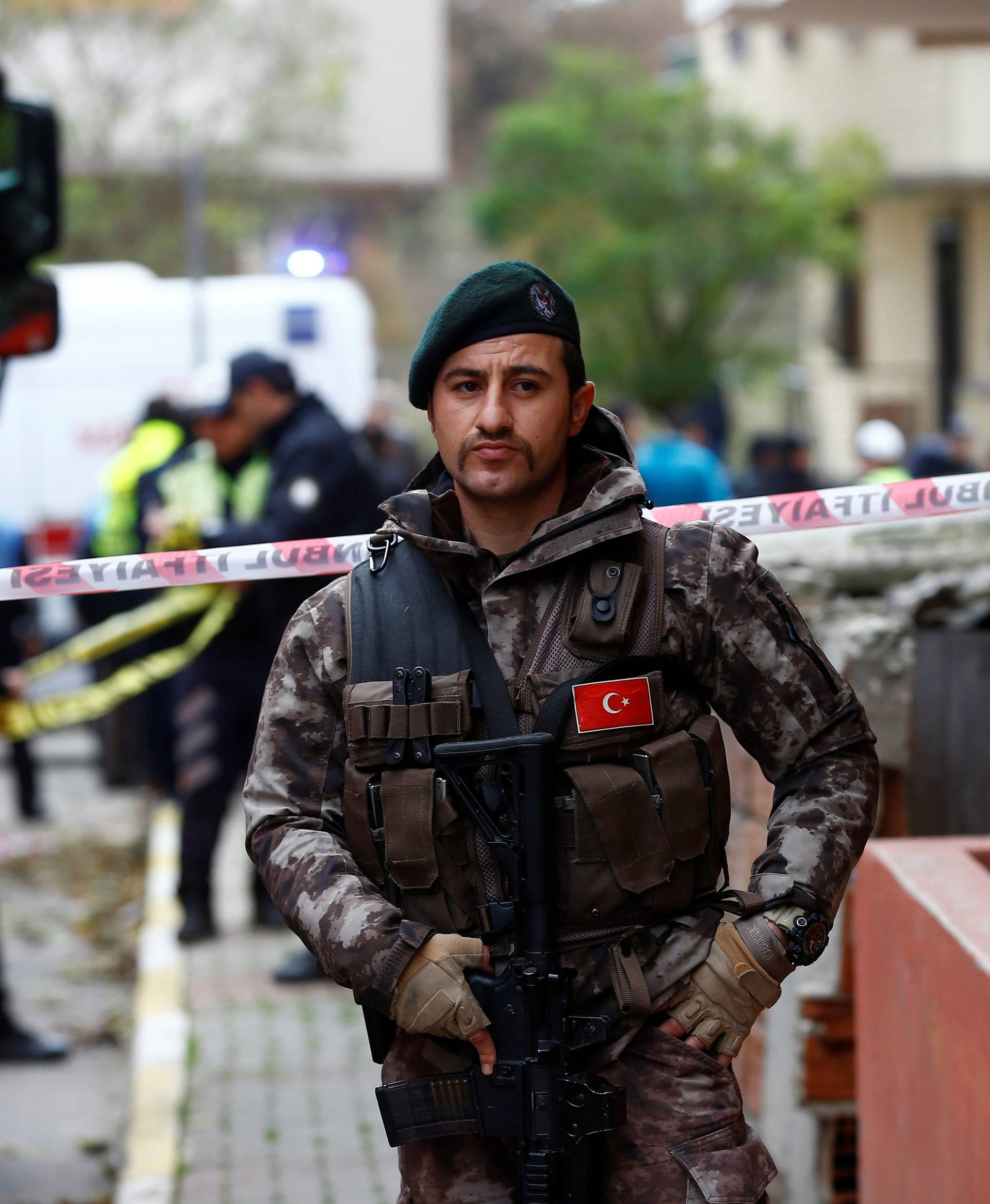 A Turkish police special forces officer stands guard in front of the site of a helicopter crash in Istanbul