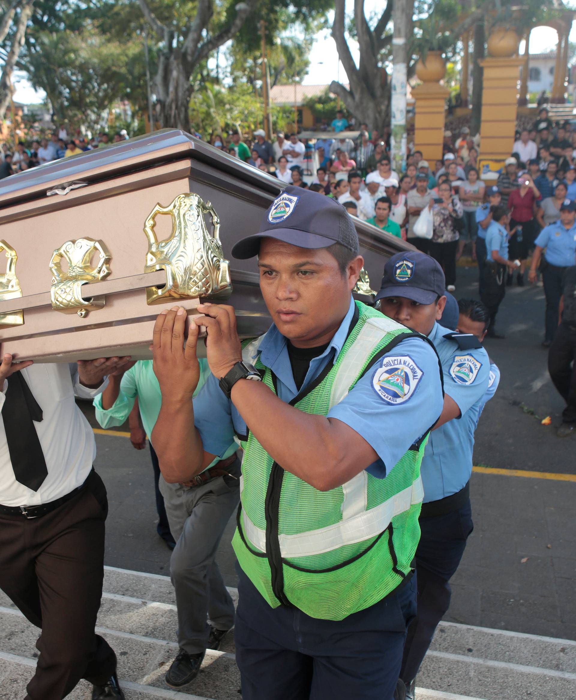 Police officers and relatives carry the coffin of Juana Aguilar, a police officer who died from injury sustained during the protests over a reform to the pension plans of the Nicaraguan Social Security Institute, toward the church in Jinotepe