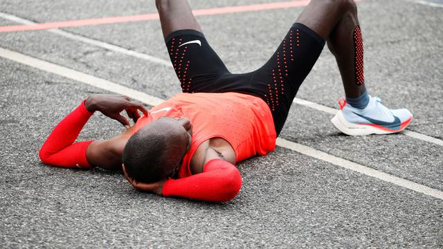 Kipchoge reacts after crossing  the finish line during an attempt to break the two-hour marathon barrier at the Monza circuit.