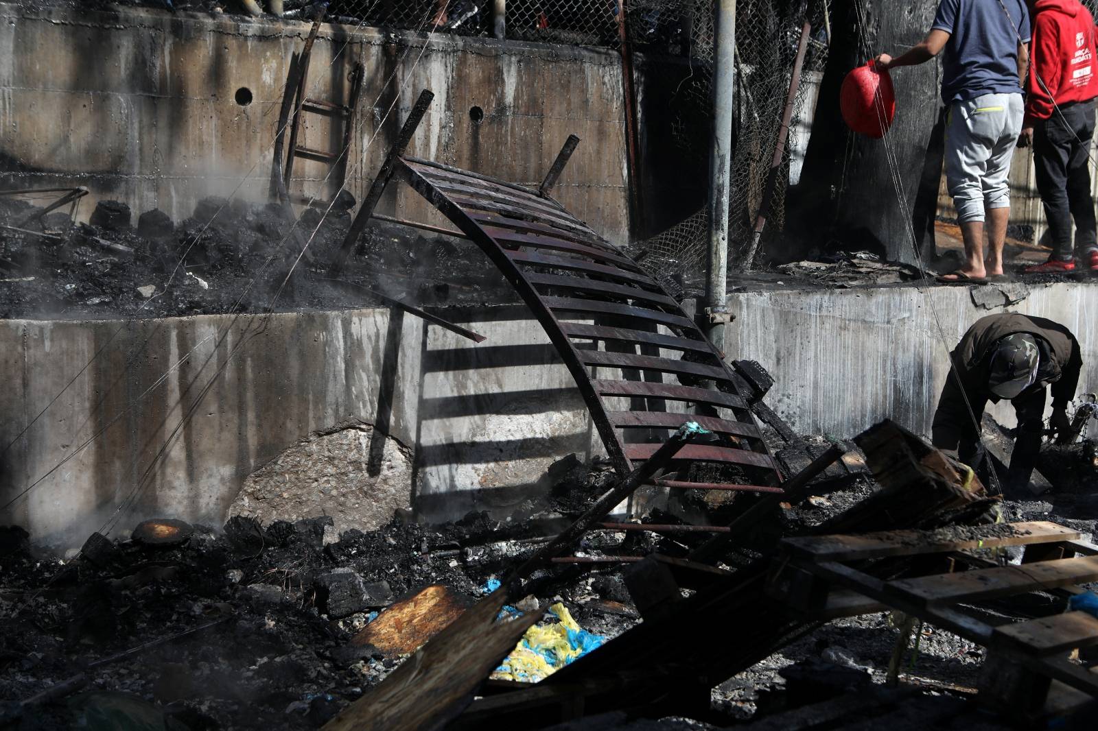 A burnt bed is seen following a fire in containers used to house refugees and migrants in the Moria camp on the island of Lesbos