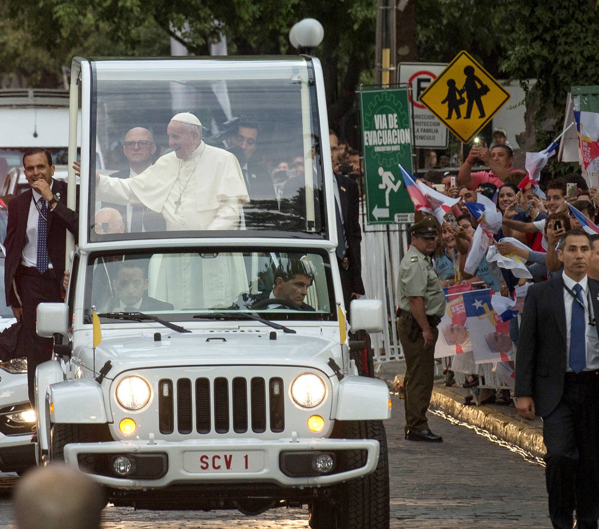 Pope Francis waves while arriving at the nunciature in Santiago