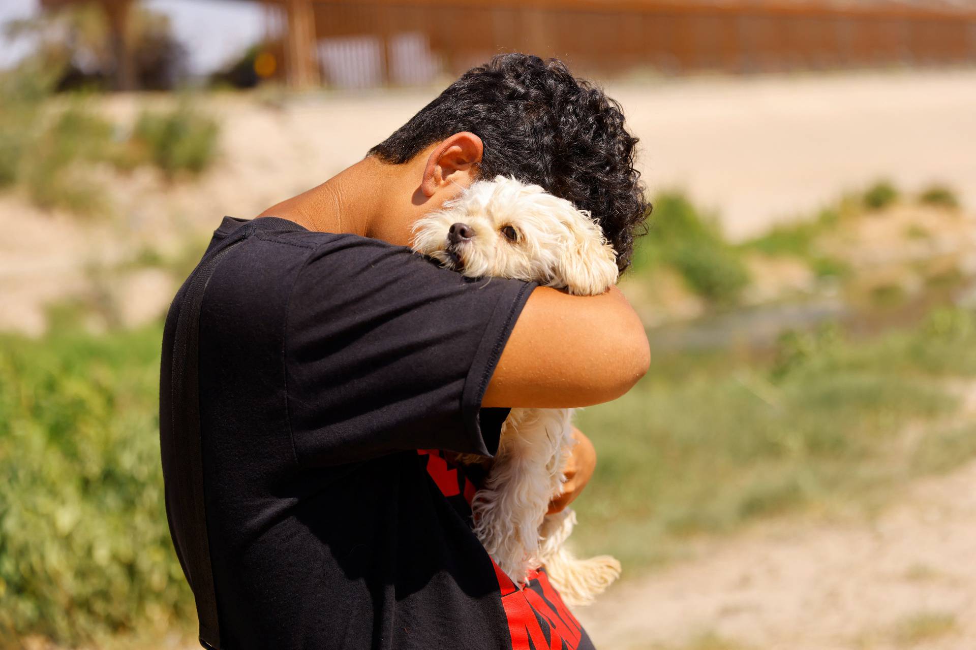 Venezuelan migrant Brayan Pinto returns to Ciudad Juarez to drop off his dog after crossing the Rio Bravo river and turning himself in to the U.S. Border Patrol in order to request asylum