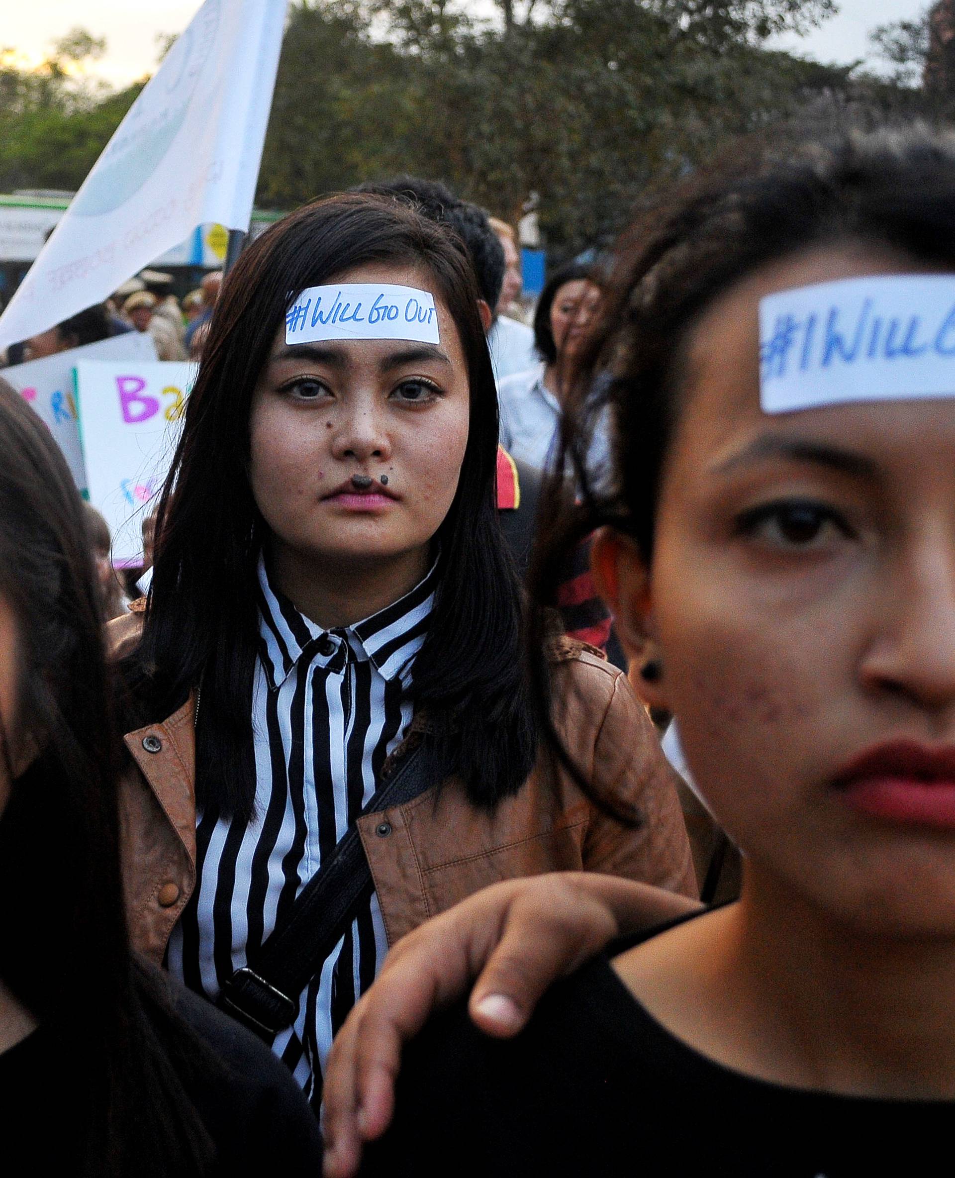 Women take part in the #IWillGoOut rally, to show solidarity with the Women's March in Washington, along a street in Bengaluru