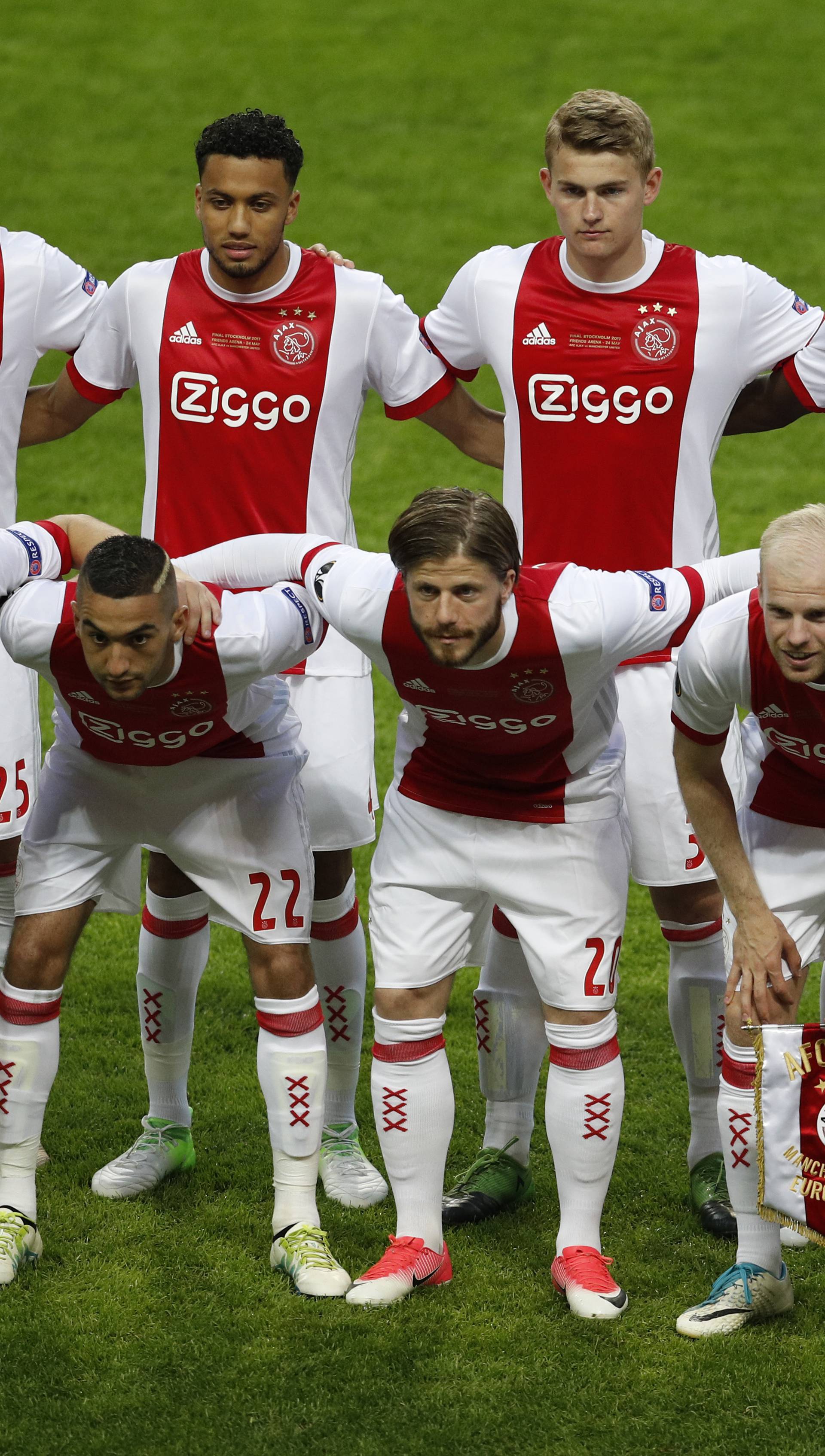 Ajax players pose for a team photo before the match
