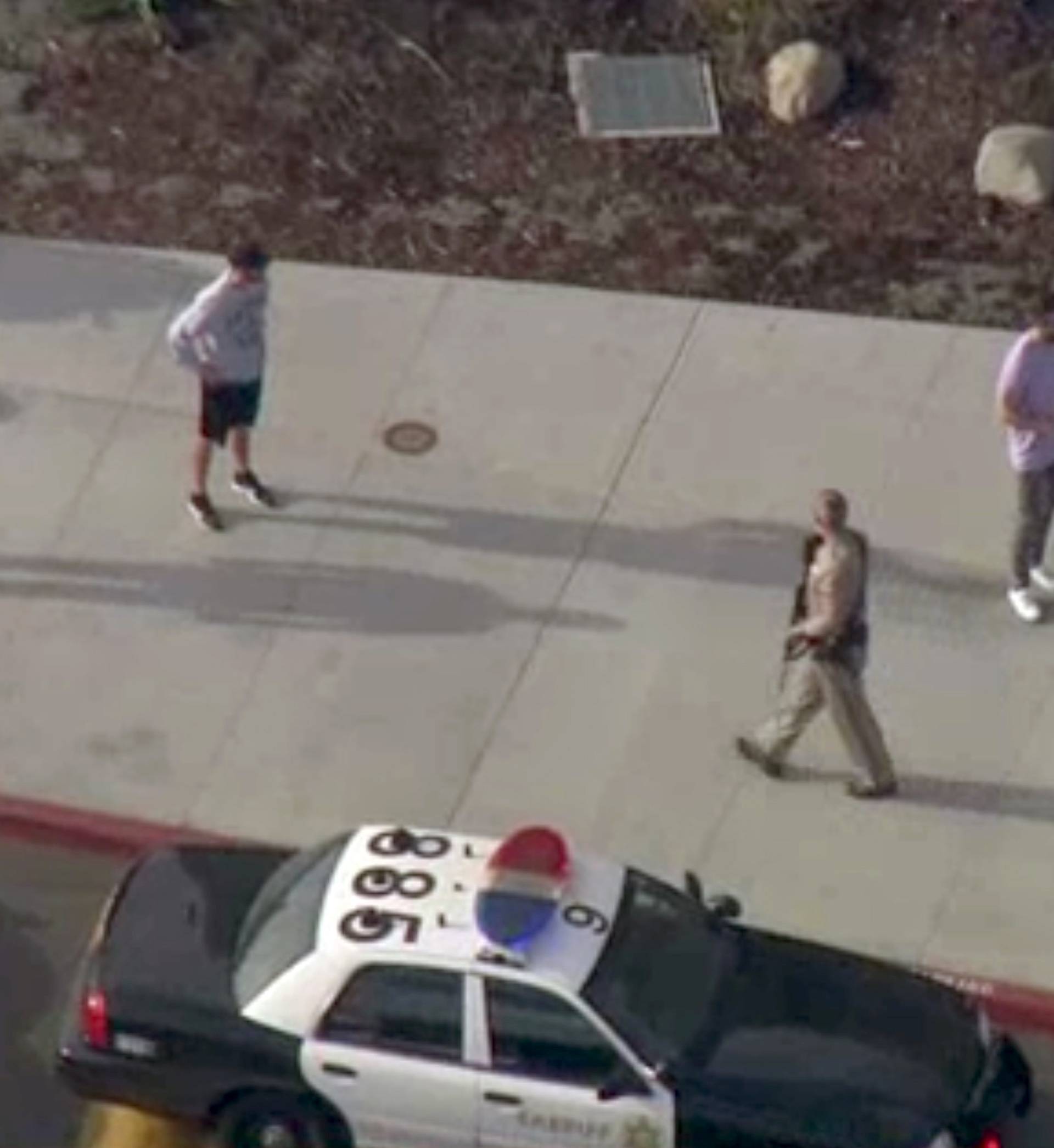 A law enforcement official leads students at the scene of a shooting at Saugus high school in Santa Clarita