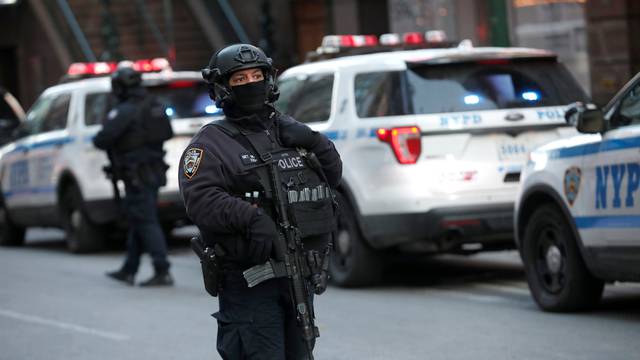 Police officers stand on a closed West 42nd Street near the New York Port Authority Bus Terminal after reports of an explosion in New York City