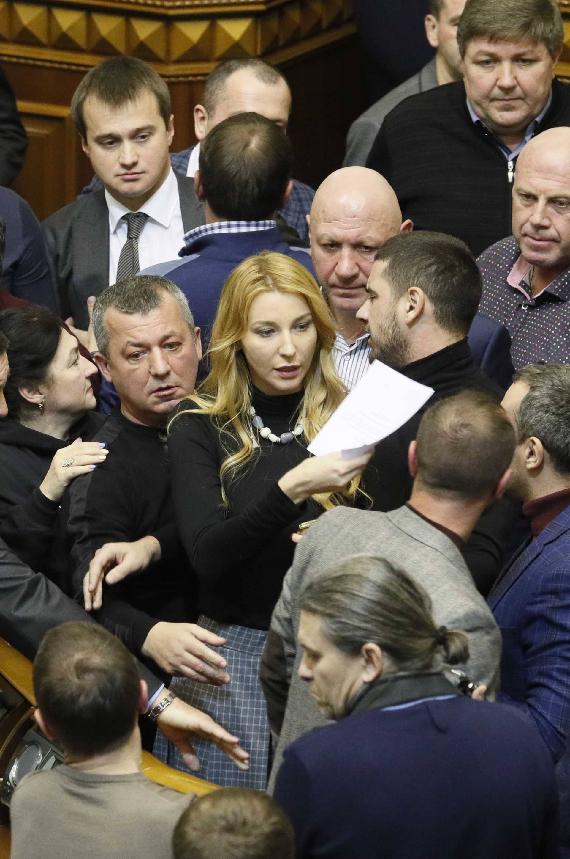 Lawmakers argue between each other during a parliament session in Kiev