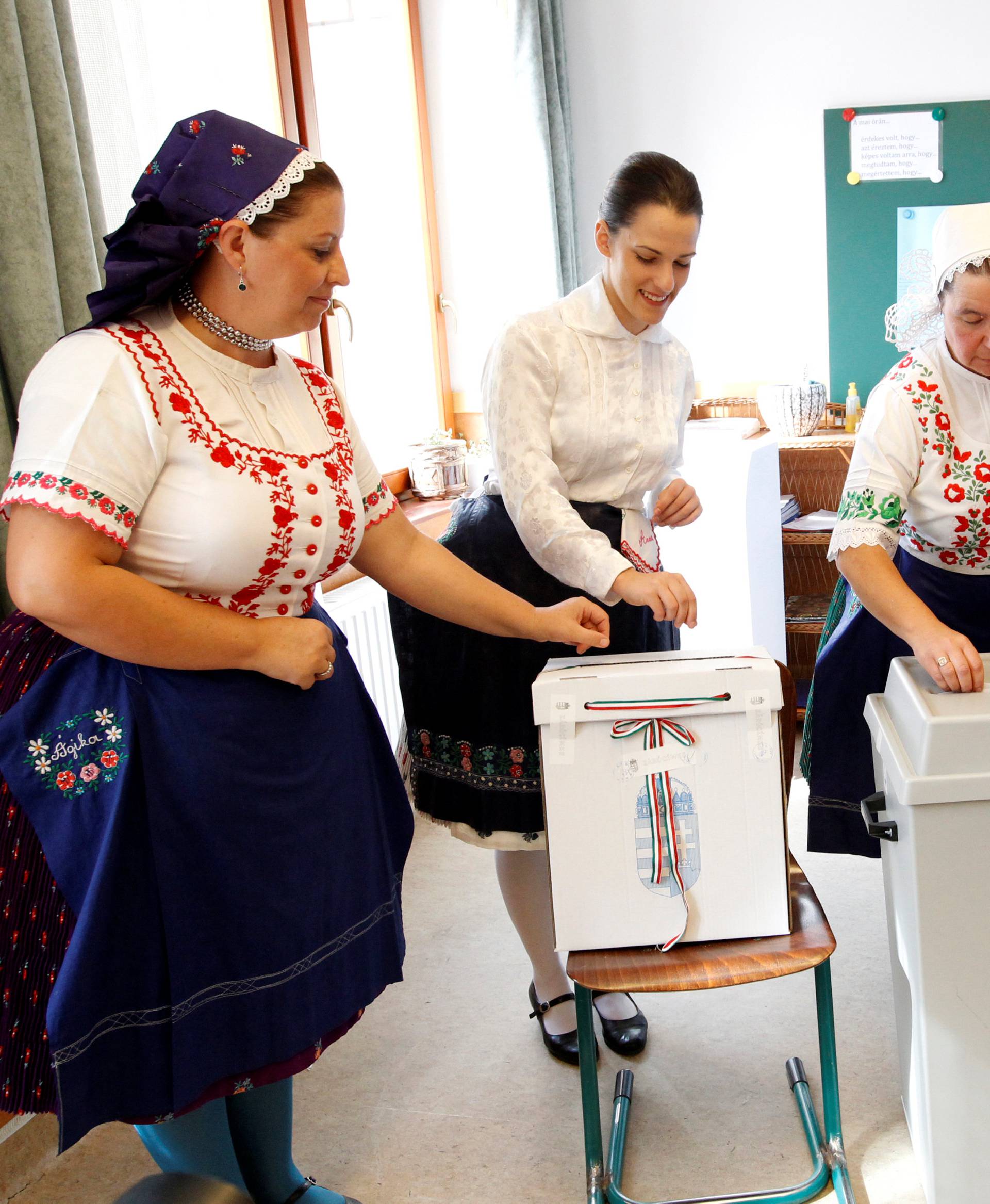 Hungarian women wearing traditional costumes attend a referendum on EU migrant quotas in Veresegyhaz