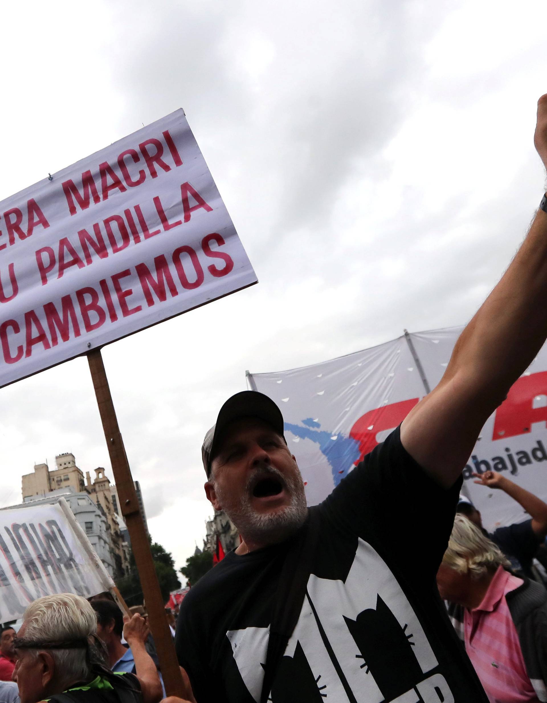 A man shouts slogans as he holds a sign during a protest against a cost increase in public and utility services in Buenos Aires