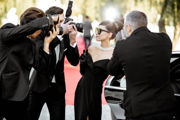 Photo reporters photographing actress ariving on the awards ceremony