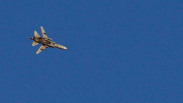 A war jet flies above Syria near the Israeli Syrian border as it is seen from the Israeli-occupied Golan Heights