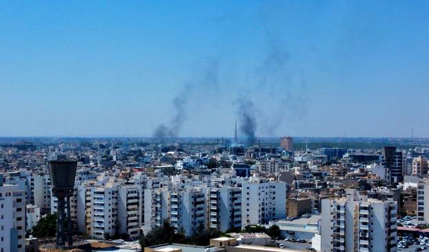 Smoke rises in the sky following clashes in Tripoli