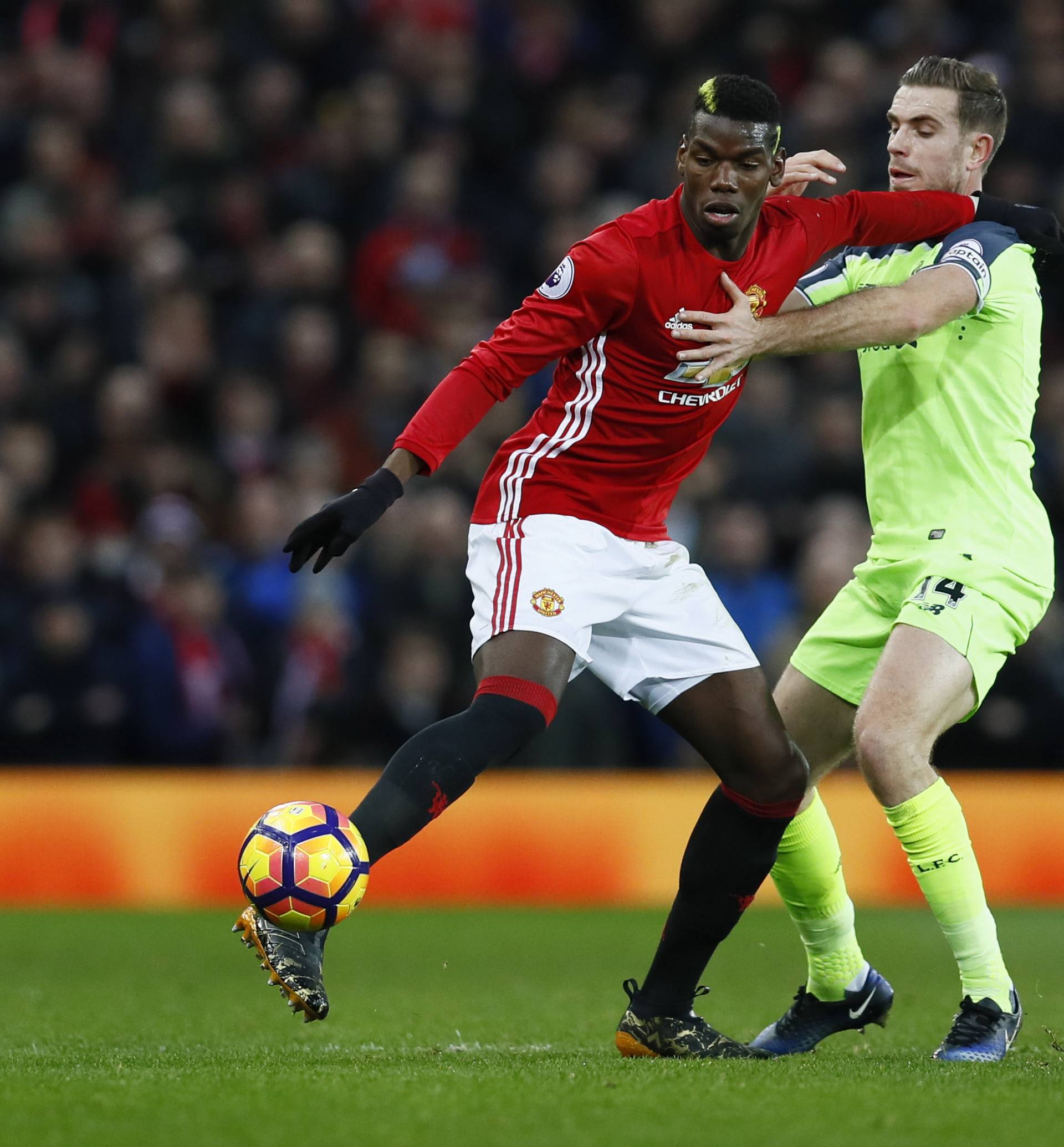 Manchester United's Paul Pogba in action with Liverpool's Jordan Henderson