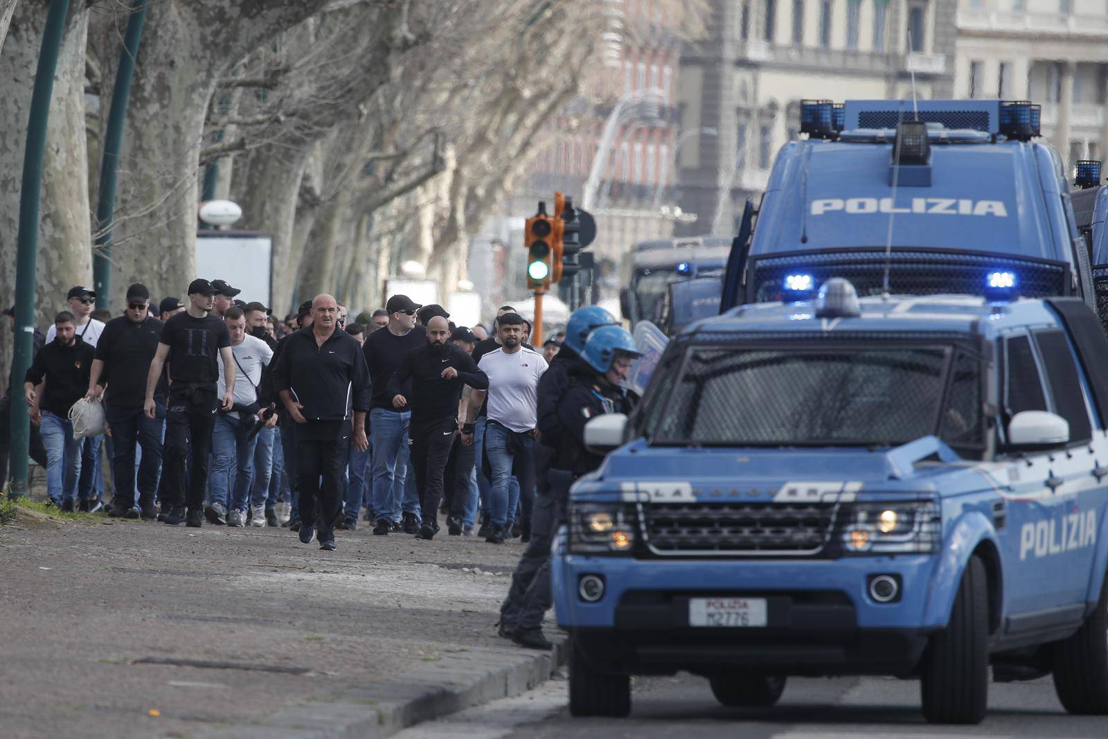 Italian police follow Eintracht Frankfurt fans walking through the streets of the city of Naples before the UEFA Champions League round of 16 return match between SSC Napoli and Eintracht Frankfurt.