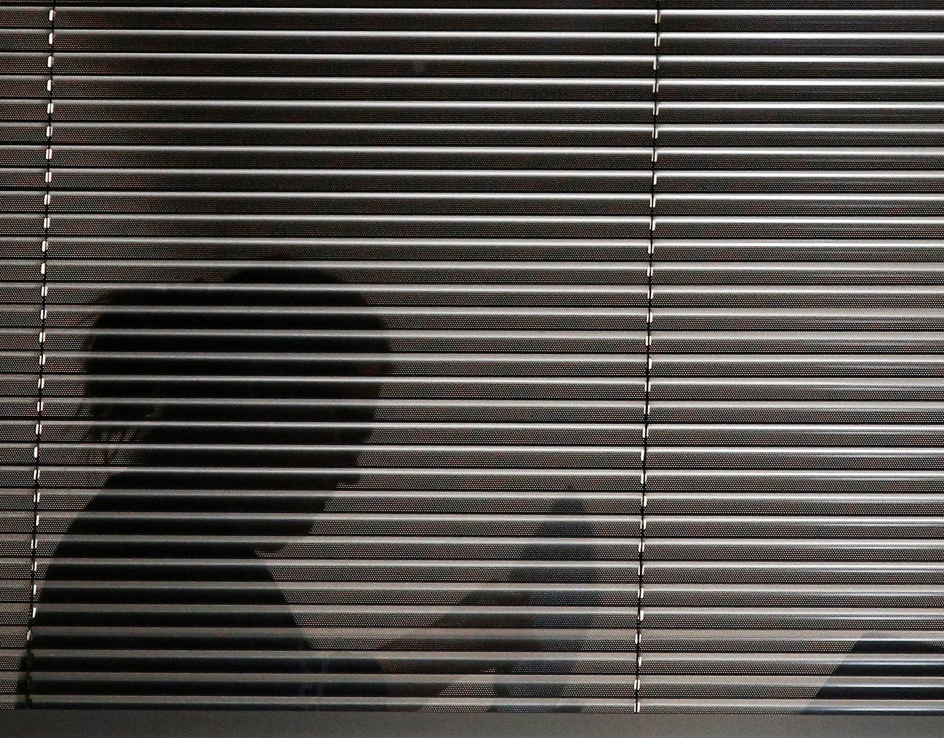 A person is seen inside the building which houses the offices of Cambridge Analytica as investigators from Britain's Information Commissioners Office entered, following the granting of a search warrant by a High Court judge, in London