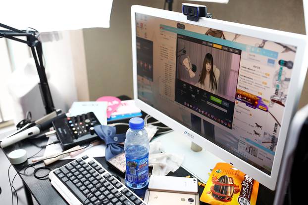 A girl broadcasts at Three Minute TV, a live streaming talent agency, in Beijing