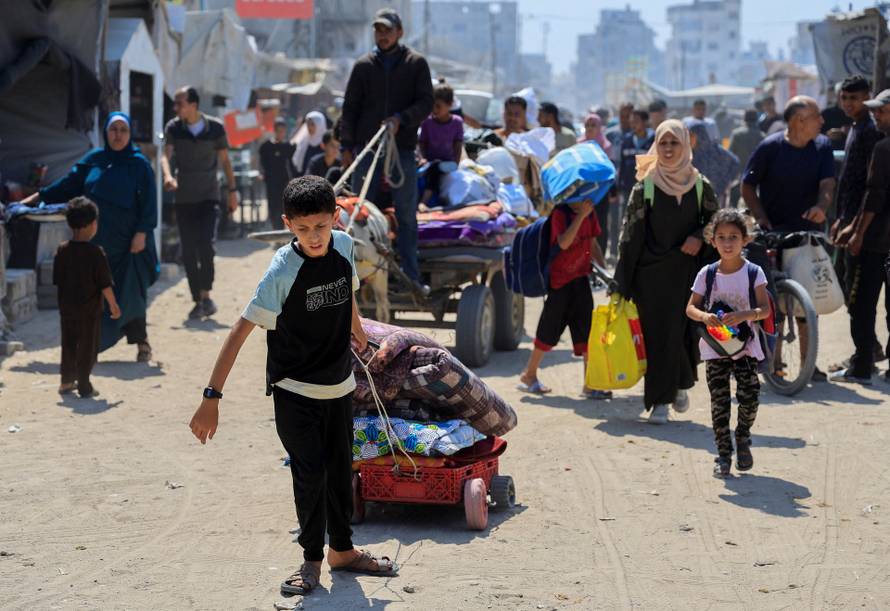 Palestinians flee with their belongings after the Israeli army issued evacuation orders, in Khan Younis, in the southern Gaza Strip