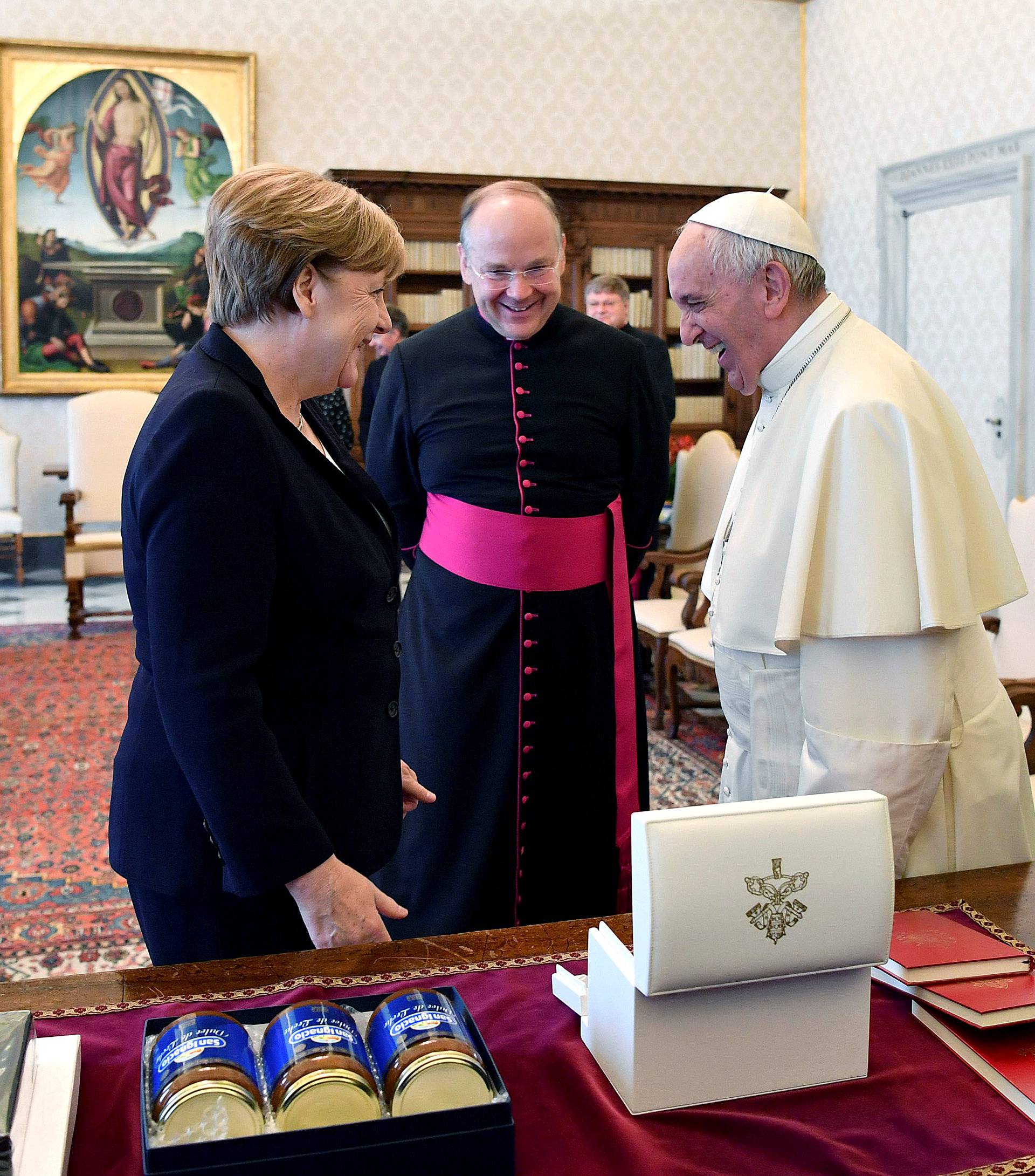 German Chancellor Merkel exchanges gifts with Pope Francis during a meeting at the Vatican
