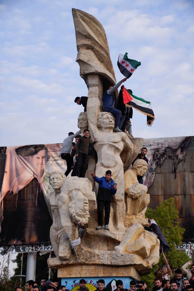 People gather at Saadallah al-Jabiri Square as they celebrate, in Aleppo