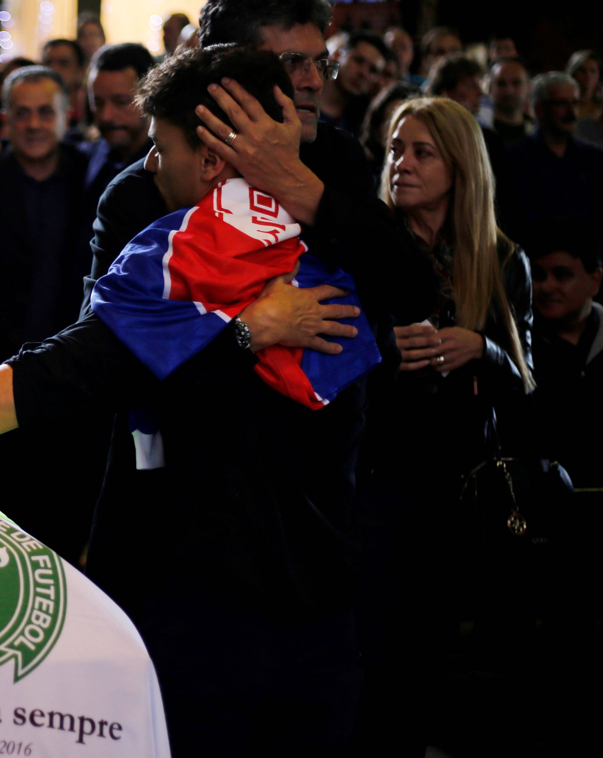 Relatives of Chapecoense soccer club head coach Caio Junior, who died in the plane crash in Colombia, participate in a ceremony to pay tribute to him in Curitiba