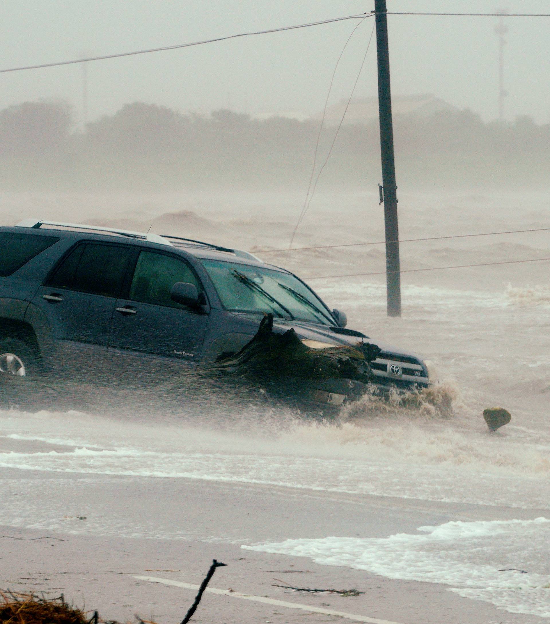 A car is surrounded by floodwaters from Hurricane Harvey in Point Comfort