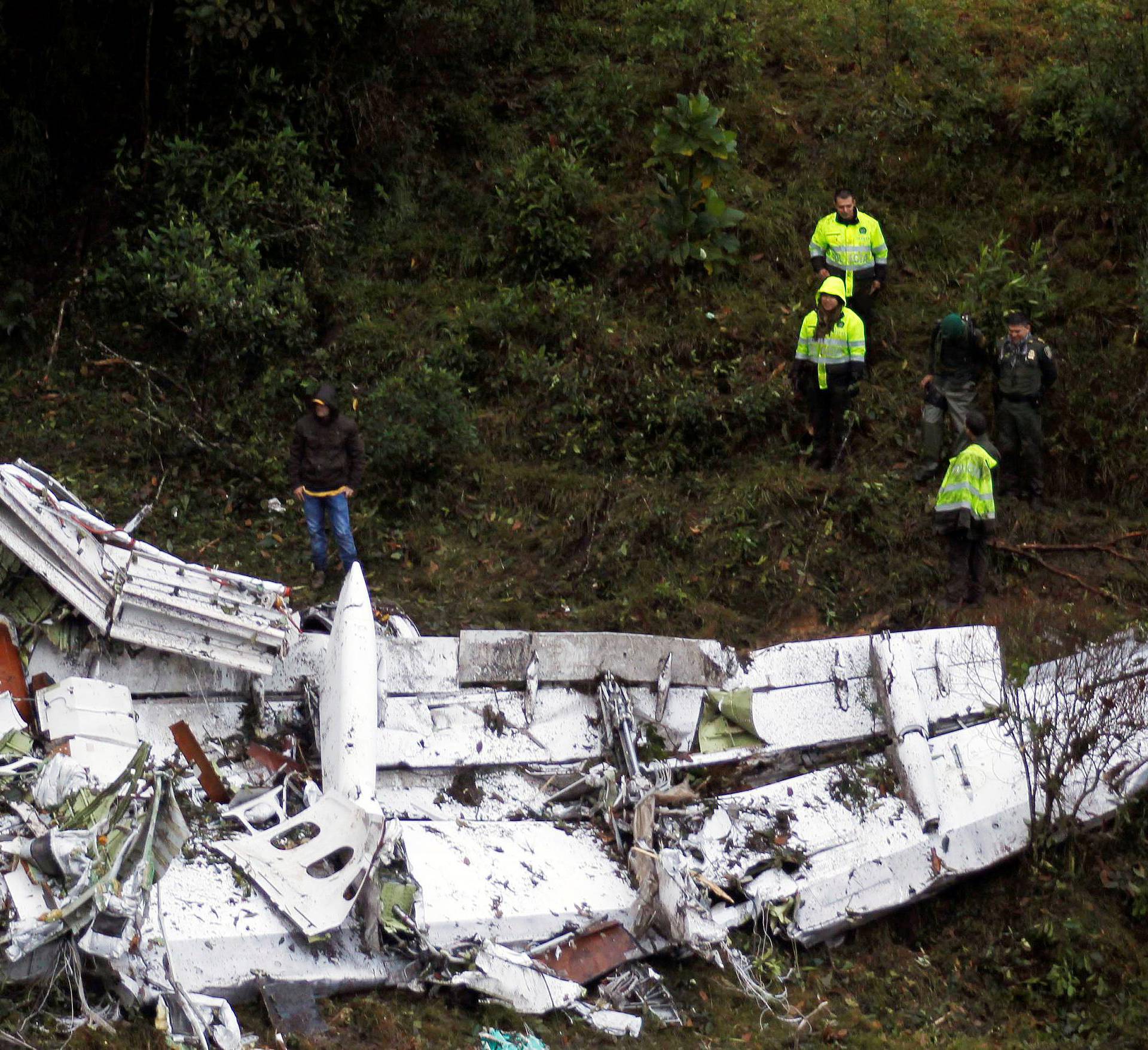 Rescue crew work in the wreckage from a plane that crashed into Colombian jungle with Brazilian soccer team Chapecoense near Medellin