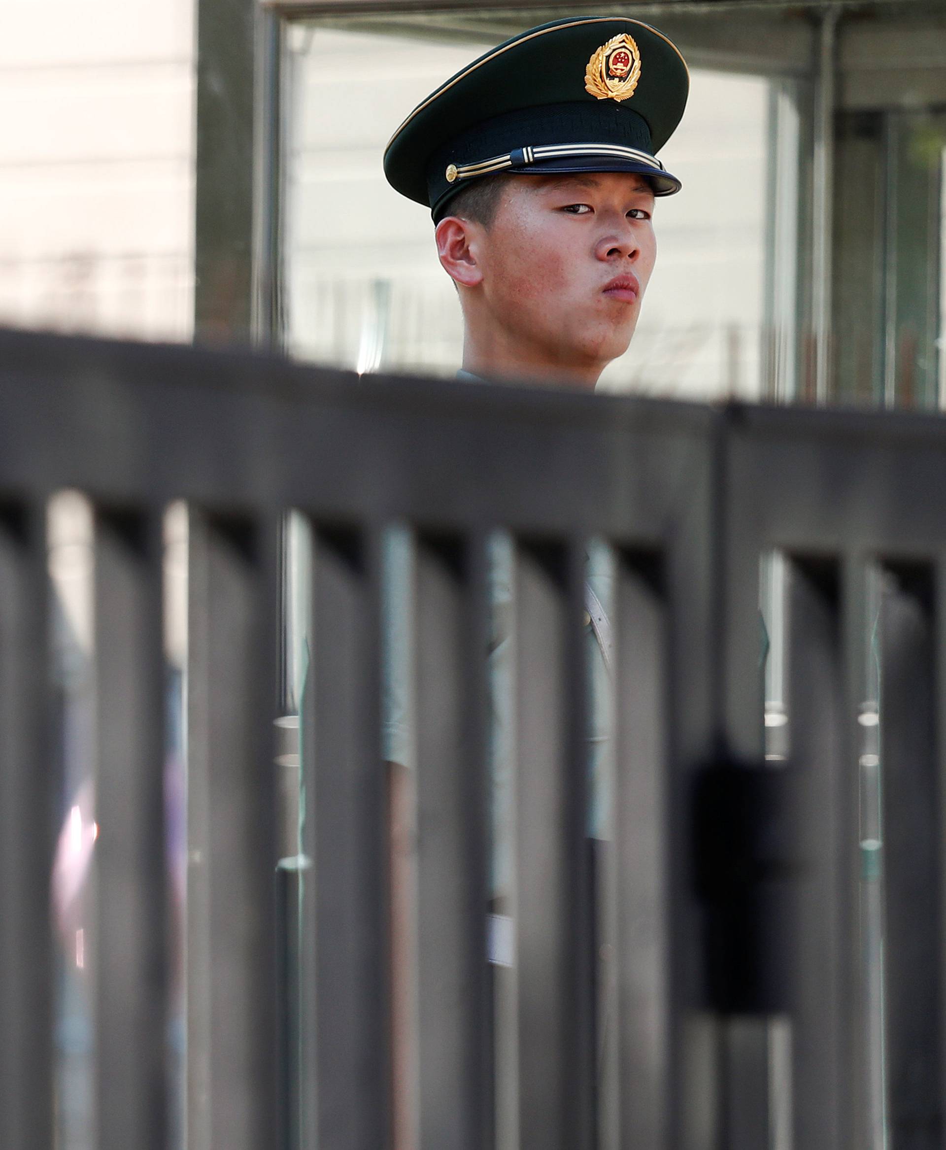 A paramilitary policeman stands guard near the site of blast at the U.S. embassy in Beijing