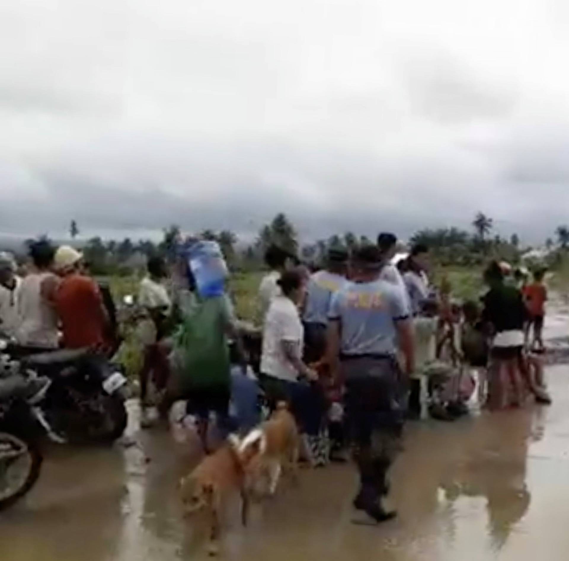 A general view shows search, retrieval, and relief operations ongoing at the flooded areas at Tzu Chi Village in Barangay Liloan