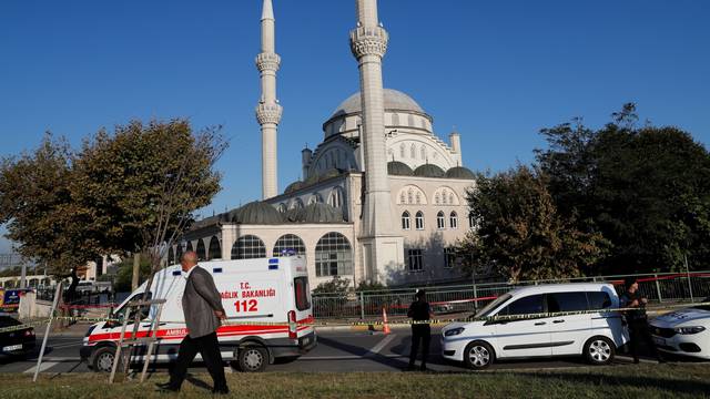 Police cars and an ambulance are parked in front of a mosque, where one of its minarets collapsed after an earthquake, in Istanbul